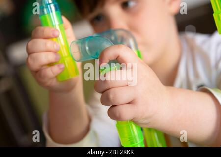Playing Little Boy with Colored Tubes Stock Photo