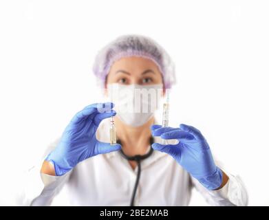 Female Doctor in Medical Protective Mask and Gloves Showing Vaccine Ampoule. Prevention and Stop  infection concept. Stop coronavirus.