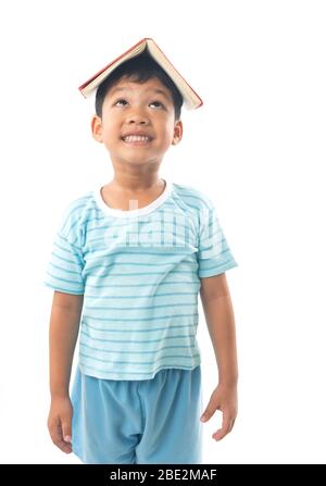 Young Asian boy student putting  book and show over head, isolated on white background Stock Photo