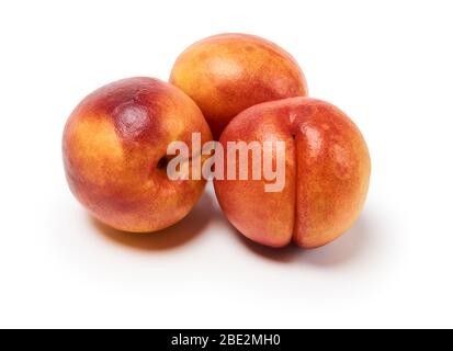 three ripe nectarines on a white background, isolated with a shadow Stock Photo