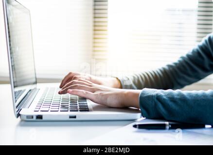 close up hand of accountant pressing and typing keyboard on laptop with free space for text above Stock Photo