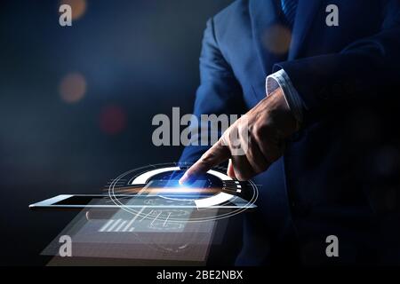 Close up hand of businessman press on tablet and using modern interface payments online shopping, technology digital marketing and financial innovatio Stock Photo