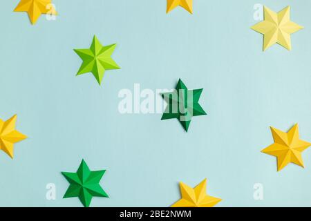 Colored paper stars over blue background Stock Photo