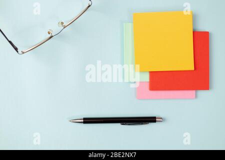 Colored Notepad papers over the desk, place for text. Stock Photo