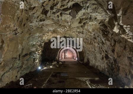 Rocky entrance and tunnel in the the Platterhofbunker or Gastehaus bunker, part of the Documentation Center Obersalzburg, Bavaria, Germany. Stock Photo