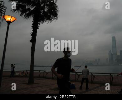 Hong Kong, China. 11th Apr, 2020. A man wearing mask jogs in Hong Kong, south China, April 11, 2020. Hong Kong's Center for Health Protection (CHP) reported on Saturday that 11 COVID-19 cases were confirmed in the past 24 hours, bringing the total infections in the region to 1,000. Credit: Li Gang/Xinhua/Alamy Live News Stock Photo