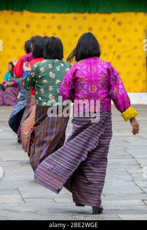 Bhutan, Punakha Dzong. Punakha Drubchen Festival, female dancers in traditional attire. Stock Photo