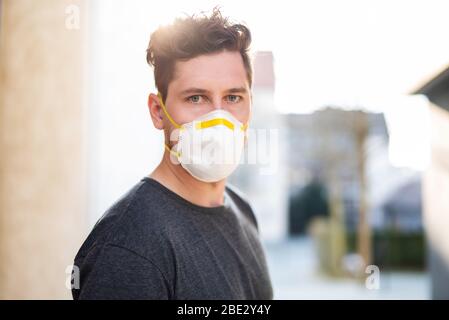 Portrait of a young man with breathing mask outdoors Stock Photo