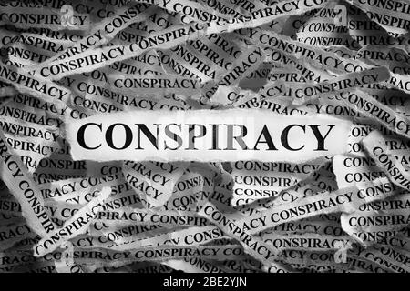 Strips of newspaper with the word Conspiracy typed on them. Black and White. Close up. Stock Photo