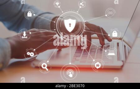 Unrecognizable african american man typing on laptop keyboard in office Stock Photo