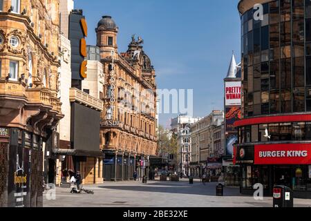 A view of empty and quiet Cranbourn St from Leicester Square, London during enforced lockdown due to coronavirus covid 19 flu pandemic outbreak Stock Photo