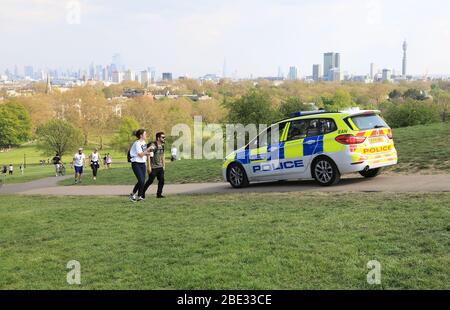 London, UK. 11th Apr, 2020. Police persuading people to keep on the move on Primrose Hill, on a hot and sunny Easter Saturday, in the middle of the coronavirus pandemic lockdown. Credit: Monica Wells/Alamy Live News