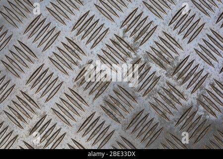 Old, dirty, alluminium checker plate. Stock Photo