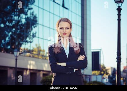 Serious woman crossed arms office building outside Stock Photo