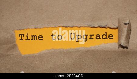 TIME TO UPGRADE written under torn paper. Innovation update in busness startup concept Stock Photo