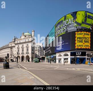 Government messages on led screen at an empty, deserted Piccadilly Circus during enforced lockdown due to coronavirus covid 19 flu pandemic Stock Photo