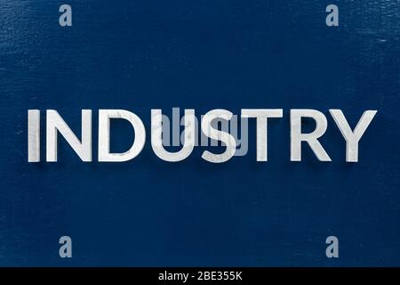 the word industry laid weith white letters over blue flat background in center of picture with directly above perspective Stock Photo