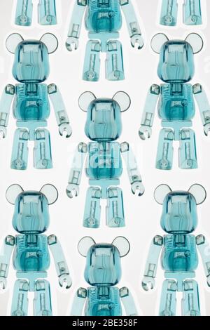 an interesting top view of transparent toy figure robots against a bright white background Stock Photo