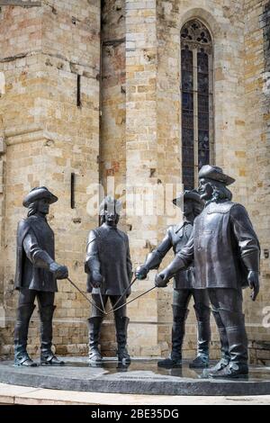 Statues of the Three Musketeers and d'Artagnan by Zurab Tsereteli outside the Cathédrale Saint-Pierre de Condom, France. Stock Photo