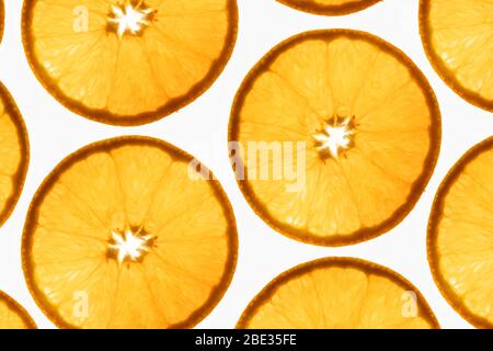 an interesting pattern of transparent orange slices against a bright white background Stock Photo
