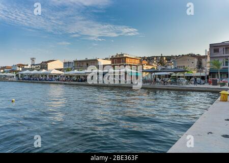 Sunset view of Argostoli in Kefalonia Greece. View of the port and the traditional houses. People enjoying their coffee or food along the embankment Stock Photo