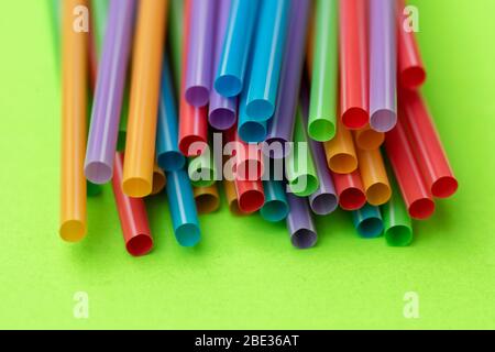 Plastic straws against colorful background Stock Photo