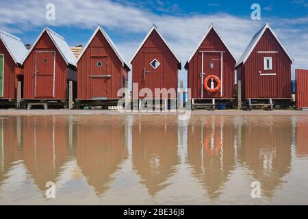 coastal huts in water reflection with lifebuoy attached Stock Photo