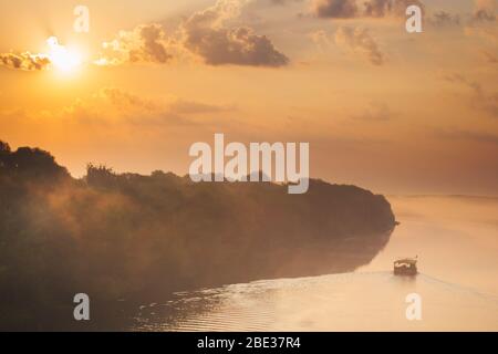 Raft floating on the river at dawn in morning Stock Photo