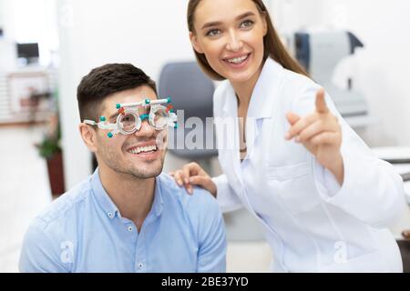 Optometrist checking patients vision with trial frame Stock Photo