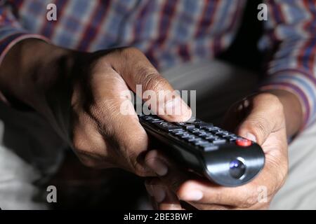 close up of man hand using tv remote  Stock Photo