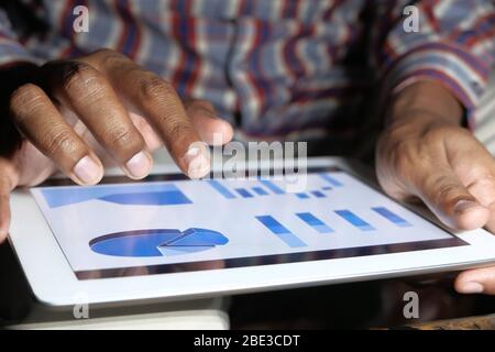 businessman analyzing financial data on digital tablet  Stock Photo