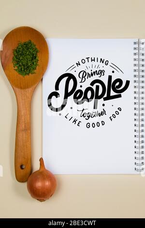 Wooden ladle with some herb spice and a blank notebook page Stock Photo