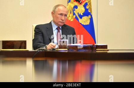 Novo-Ogaryovo, Moscow, Russia. 11th Apr, 2020. Russian President Vladimir Putin, holds a video conference meeting on the rocket and space industry from his residence at the Novo-Ogaryovo April 10, 2020 outside Moscow, Russia. Putin is holding meetings by teleconference from his residence due to the COVID-19, coronavirus pandemic. Credit: Alexei Druzhinin/Kremlin Pool/Alamy Live News Stock Photo