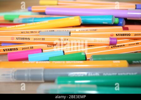 assorted coloured pens on desk Stock Photo