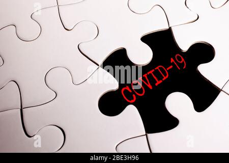 jigsaw puzzle with Covid-19 words. Health concept. Stock Photo