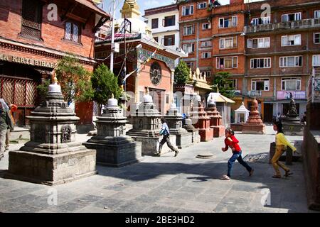 Nepal, Kathmandu, Buddhist, Temple, Stupa, Kaathe Swyambhu Shee: Gha: Chaitya, Square, Statue, Sculpture, Art, People, Boys, Kids, Children, Play Stock Photo