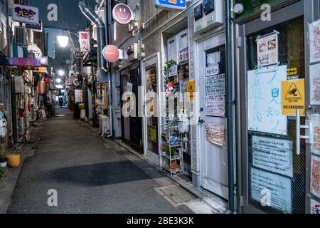 A view of a semi deserted Golden Gai, famous nightlife area in Shinjuku.The Japan government declared a state of emergency to cover Tokyo, Osaka, Saitama, Kanagawa, Chiba, Hyogo and Fukuoka prefectures from the 7th April and will continue until May 6. Tokyo governor Yuriko Koike has asked restaurants and bars to be closed at 8pm as COVID-2019 virus spreads. Stock Photo