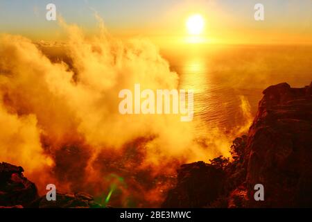 Magic Sunset in the clouds over the Atlantic ocean. Photo taken from Table Mountain near Cape Town in South Africa. Stock Photo