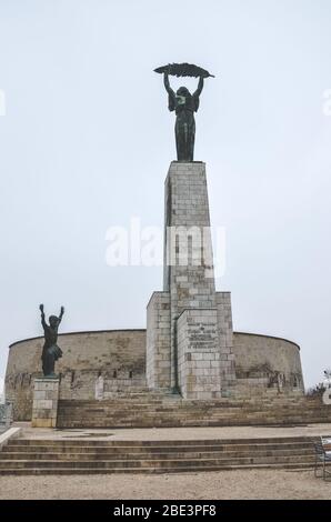 Budapest, Hungary - Nov 6, 2019: Liberty Statue on the top of the Gellert Hill in the Hungarian capital. In remembrance of the Soviet liberation of Hungary during World War II. Vertical photo. Stock Photo