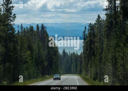 Grand Teton National Park, Wyoming / USA - July 16, 2014:  A view of Jackson Lake as seen from John D. Rockefeller Jr. Memorial Parkway with distant m Stock Photo