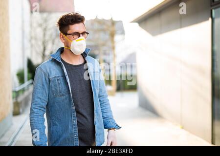 Portrait of a young man with breathing mask outdoors Stock Photo