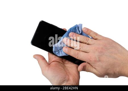 Close up view of male hands holding mobile phone during sanitizing. COVID 19. Health concept. Attention coronavirus. Stock Photo