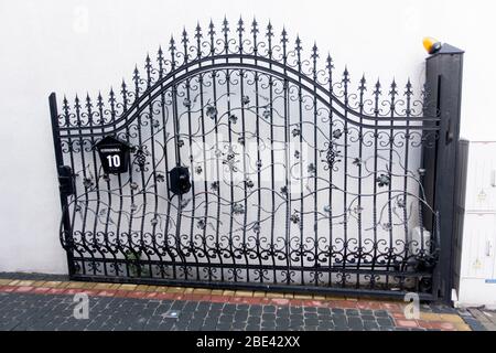 Beautiful wrought iron decorative open gate. Tomaszow Mazowiecki Central Poland Stock Photo