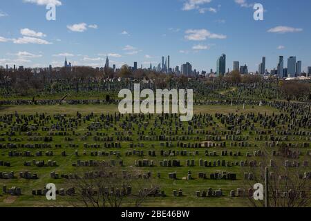 New York, USA. 11th Apr, 2020. Photo taken on April 11, 2020 shows the Calvary Cemetery, which is closed to visitors due to the coronavirus pandemic, in Queens of New York, the United States. The total number of deaths due to COVID-19 in the United States topped 20,000 Saturday afternoon, according to data compiled by the Center for Systems Science and Engineering (CSSE) at Johns Hopkins University. Credit: Michael Nagle/Xinhua/Alamy Live News Stock Photo