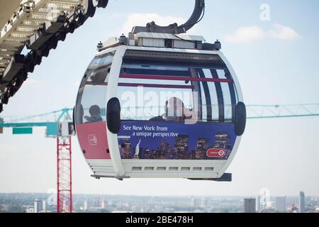 A single car on the Emirates Air Line cable car gondola ride over the Thames at the Royal Docks in London, England, United Kingdom.