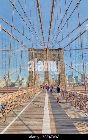 Tourists sightseeing the Brooklyn Bridge in New York Stock Photo