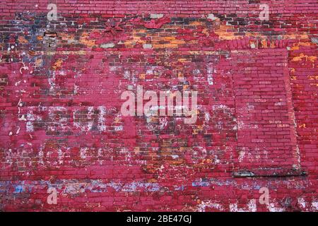 Old  fading painted bill board on side of brick building. Stock Photo