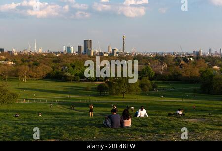 London, UK. 11th Apr, 2020. People relax on the Primrose Hill in London, Britain on April 11, 2020. The death toll of those hospitalized in Britain who tested positive for the novel coronavirus reached 9,875 as of Friday afternoon, marking a daily increase of 917, the Department of Health and Social Care said Saturday. As of Saturday morning, the number of confirmed cases of COVID-19 in Britain hit 78,991, said the department. Credit: Han Yan/Xinhua/Alamy Live News