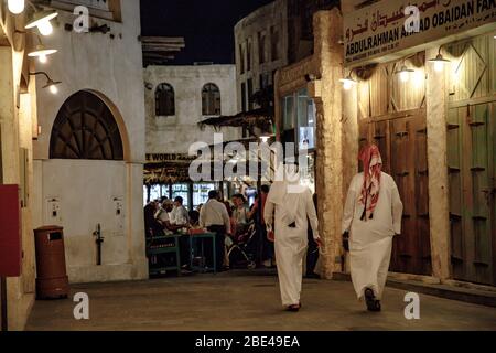 Two Qataris walking in Souq Waqif in a weekday Stock Photo