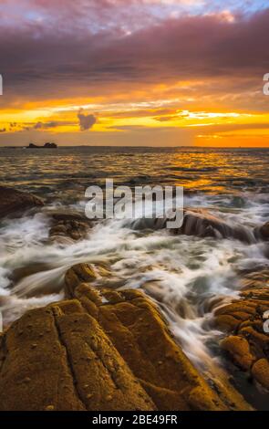 Sunset over the rocks along the French Atlantic shoreline, long exposure; Perharidi, Brest, France